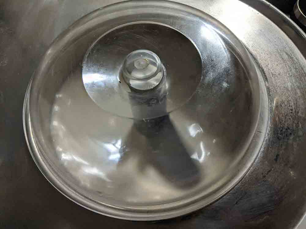 Top down view of a silver ice cream maker.