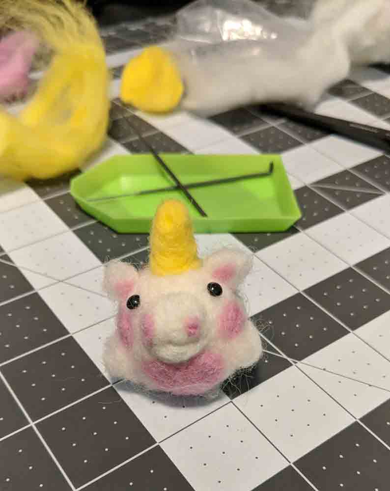 Small chubby white unicorn with pink cheeks, belly, and ears.
